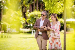 A couple walks through the garden at Giardino Ascona